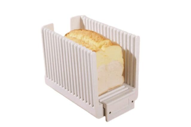 A loaf of bread in a bread slicing guide