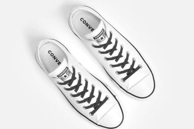 Black no-tie laces on a pair of white low-top shoes