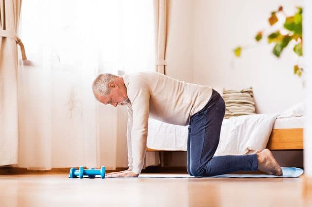 Elderly man doing rehabilitation exercises