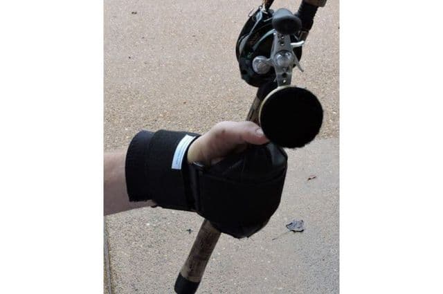 A black wrist guard designed to help hold fishing rods