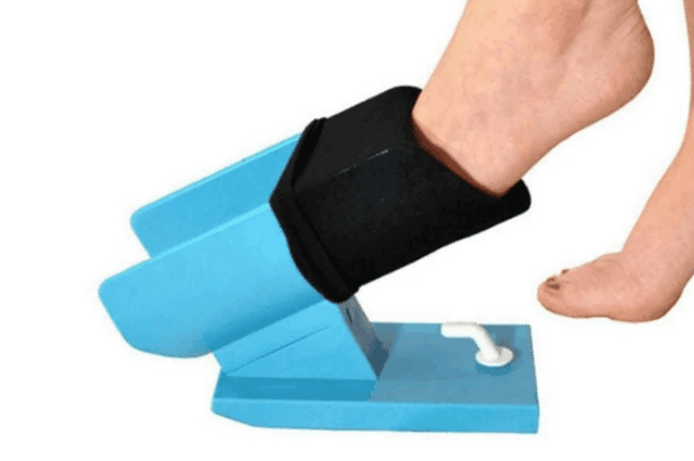 A standing sock aid that sits on the ground and helps slip socks on without too much bending