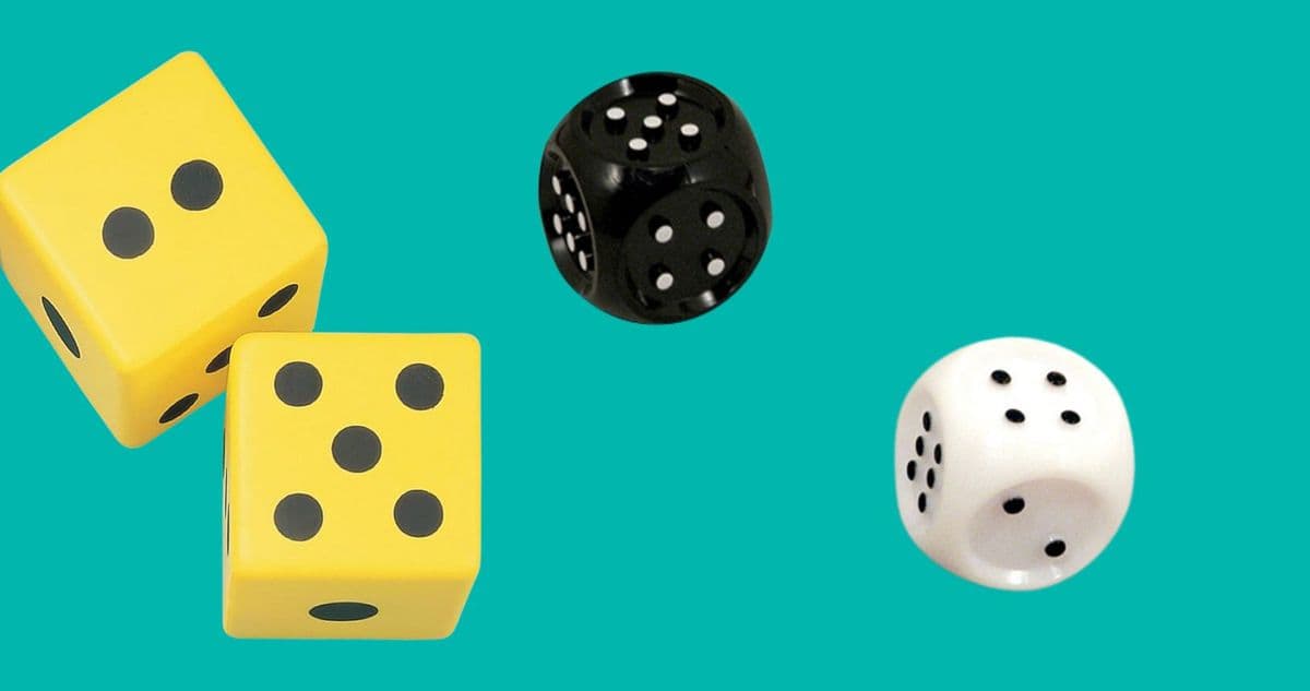 One black dice, one white dice, and two yellow die