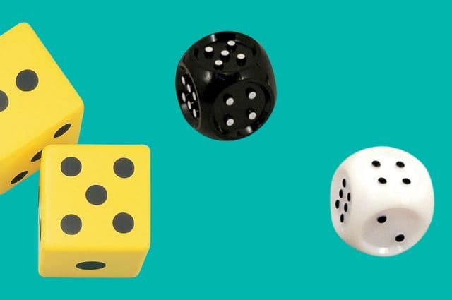 One black dice, one white dice, and two yellow die