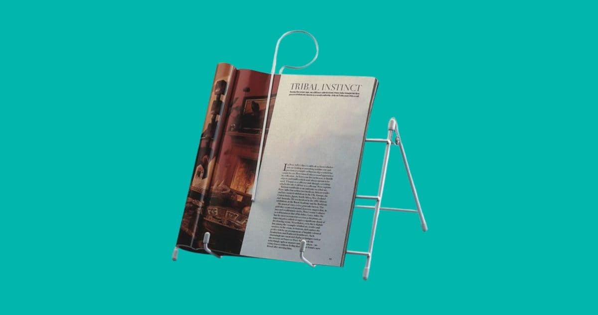 A white book stand holding an open book