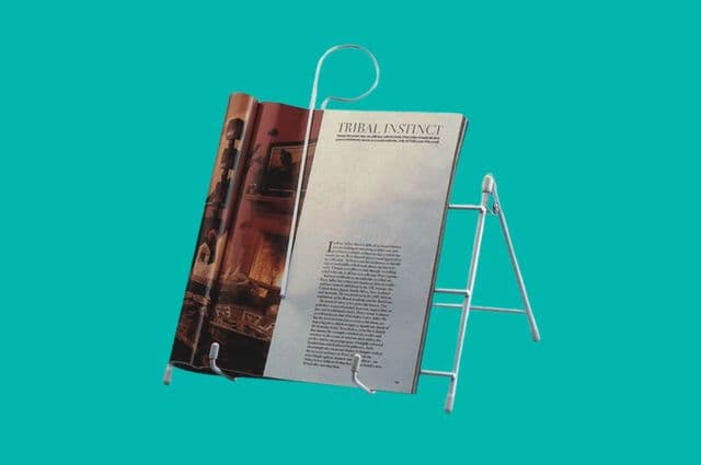 A white book stand holding an open book