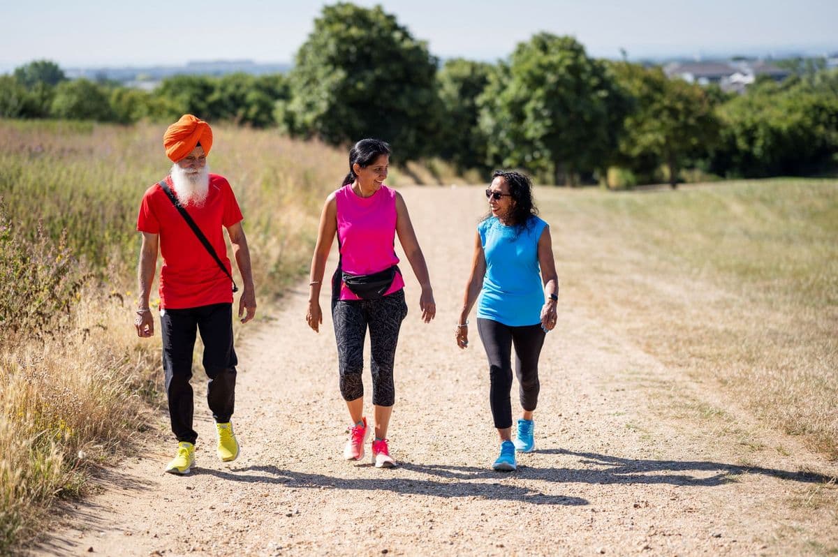 3 friends in colourful exercise clothes out for a walk.