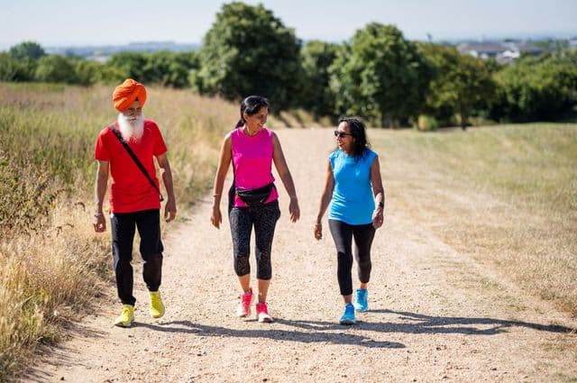 3 friends in colourful exercise clothes out for a walk.