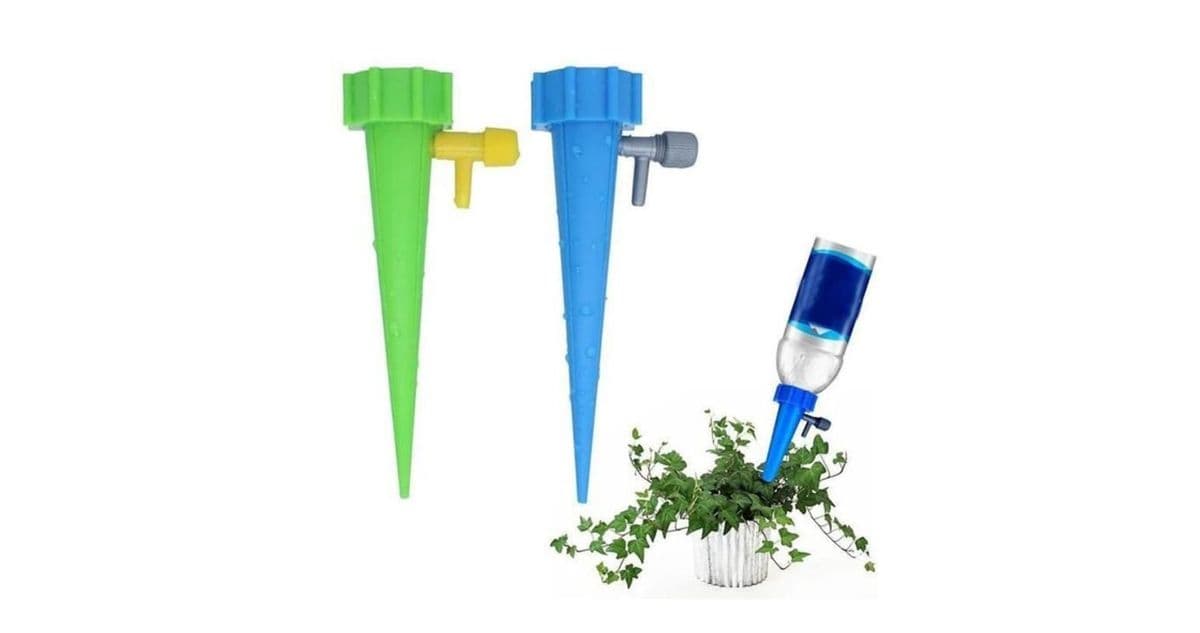Two aqua spikes and one being used to water a potted plant