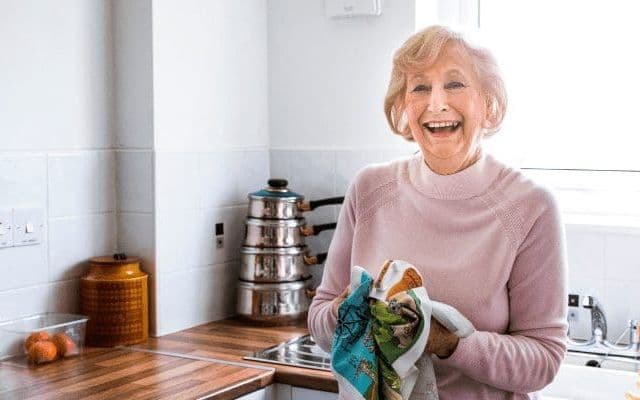 happy older lady in the kitchen