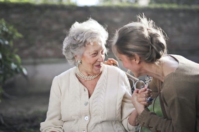 Elderly lady with her carer