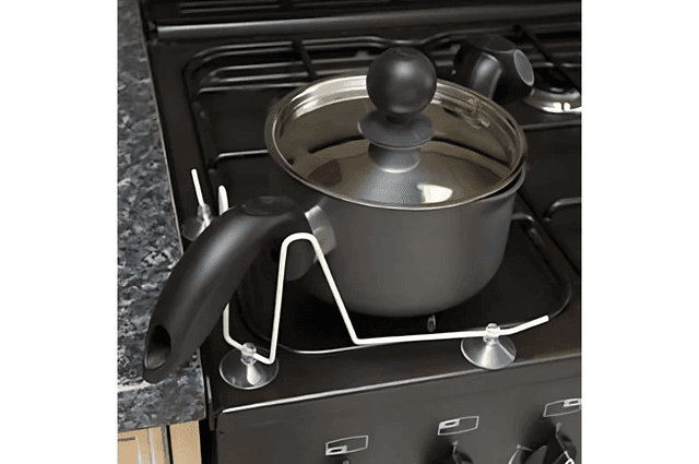 A frame that attaches to stovetops and keeps pans in place