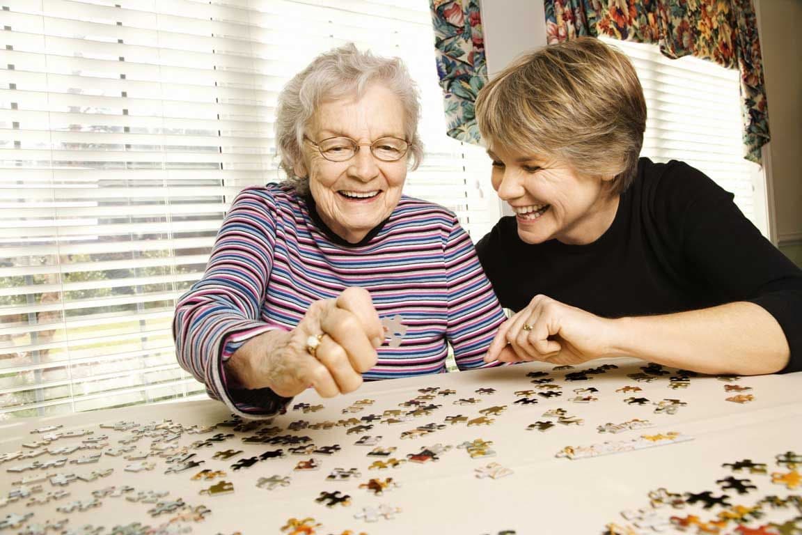 Older-woman-and-adult-woman-doing-puzzle-together