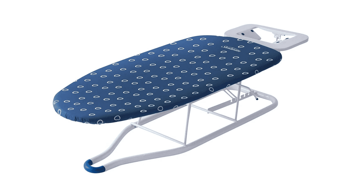 A blue tabletop ironing board with a blue and white cover
