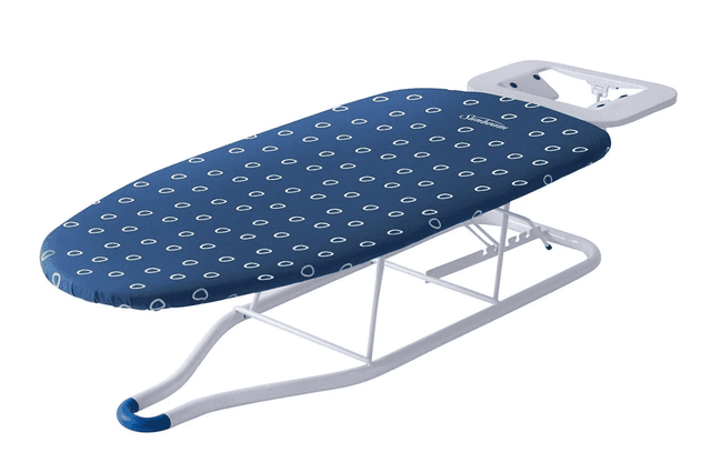 A blue tabletop ironing board with a blue and white cover