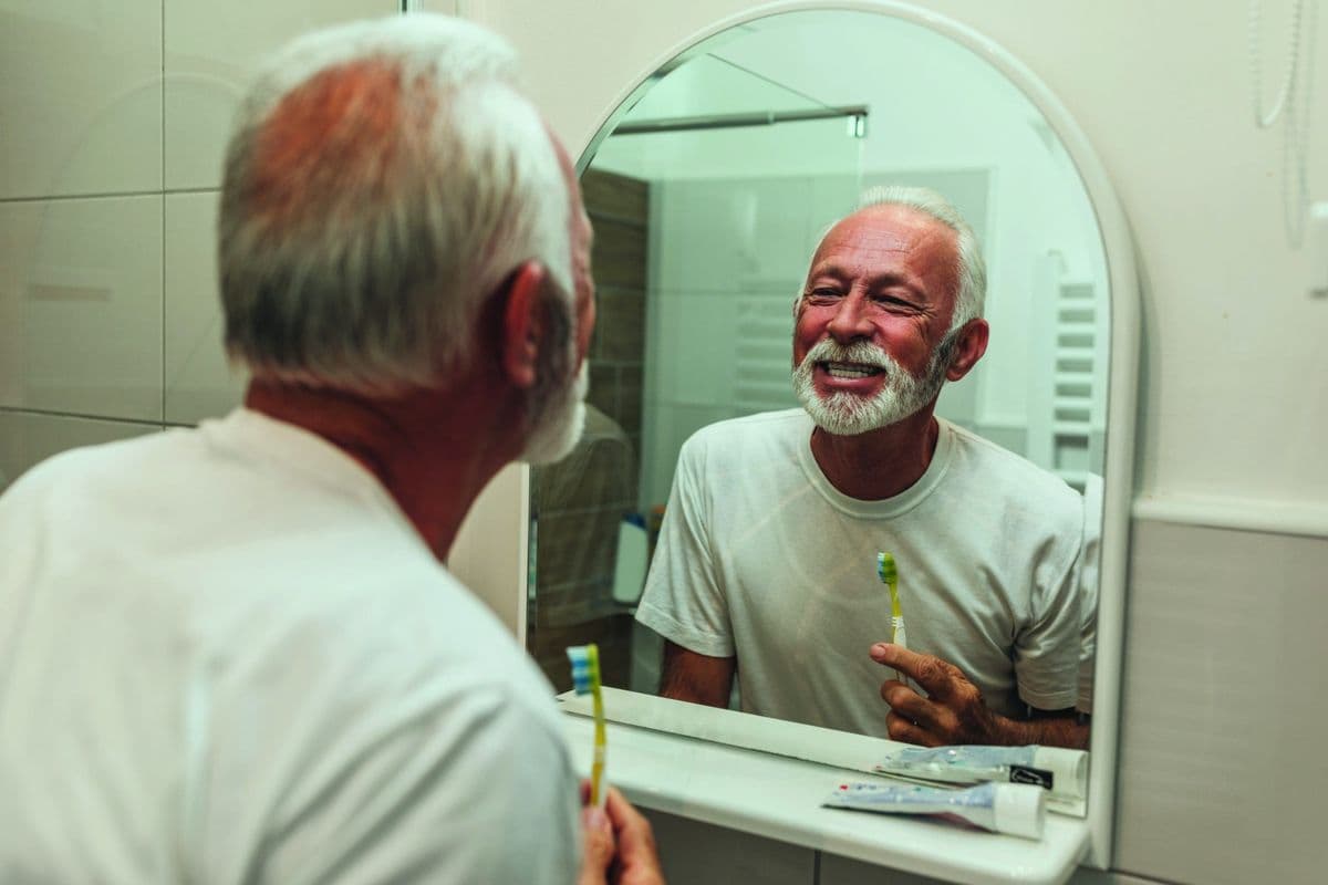 An older Man brushing his teeth