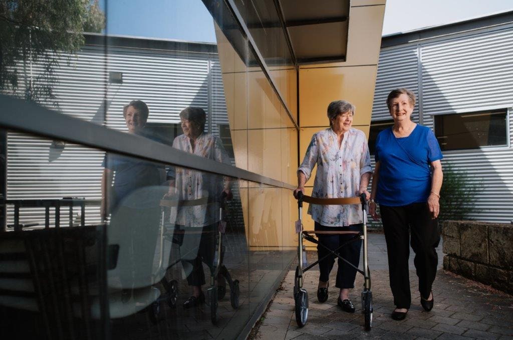 Two elderly ladies - one with a walker