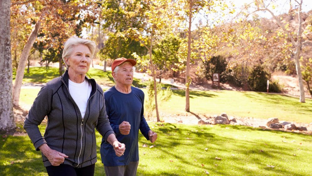 Elderly couple pace walking for exercise