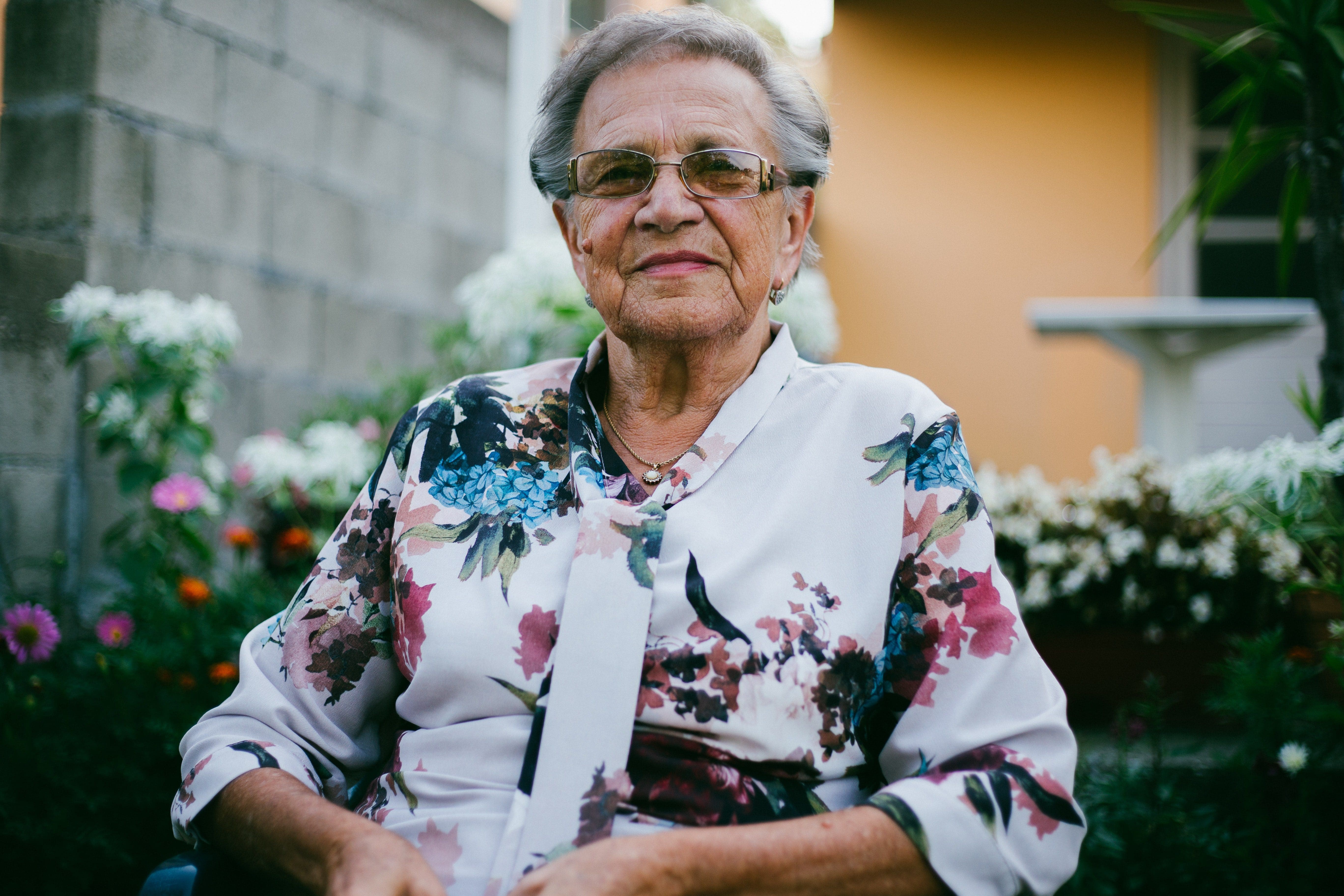 Elderly lady in a flowery top outside