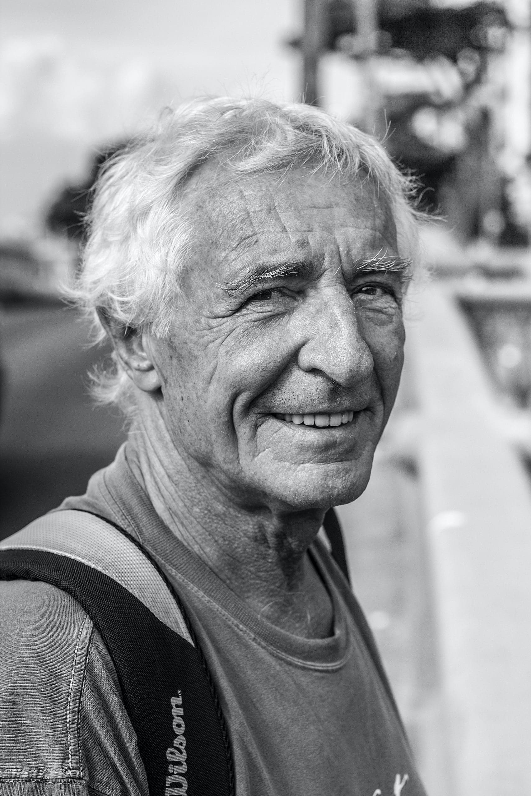 Older man outside smilingg to camera