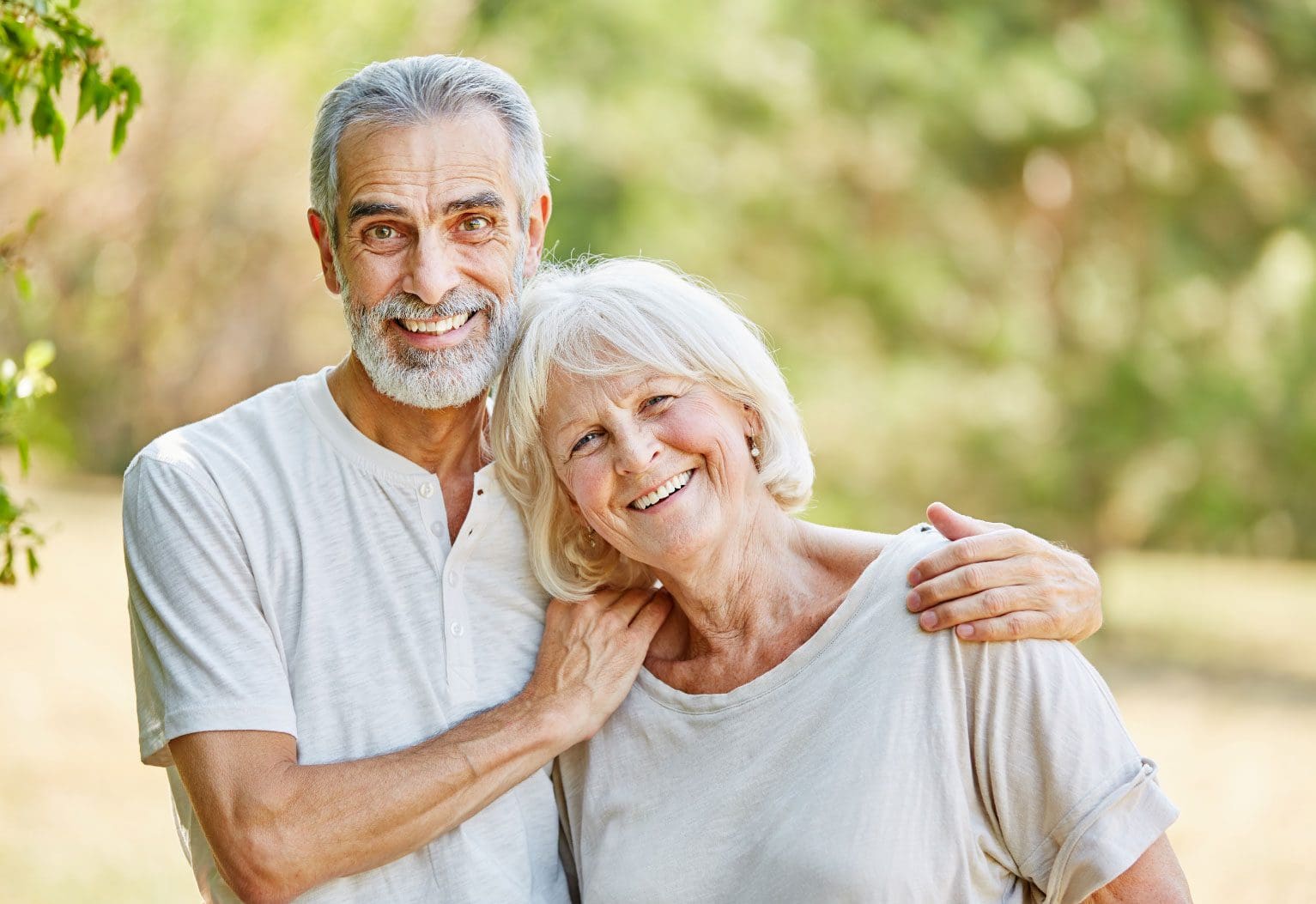 Smiling elderly couple in nature surround