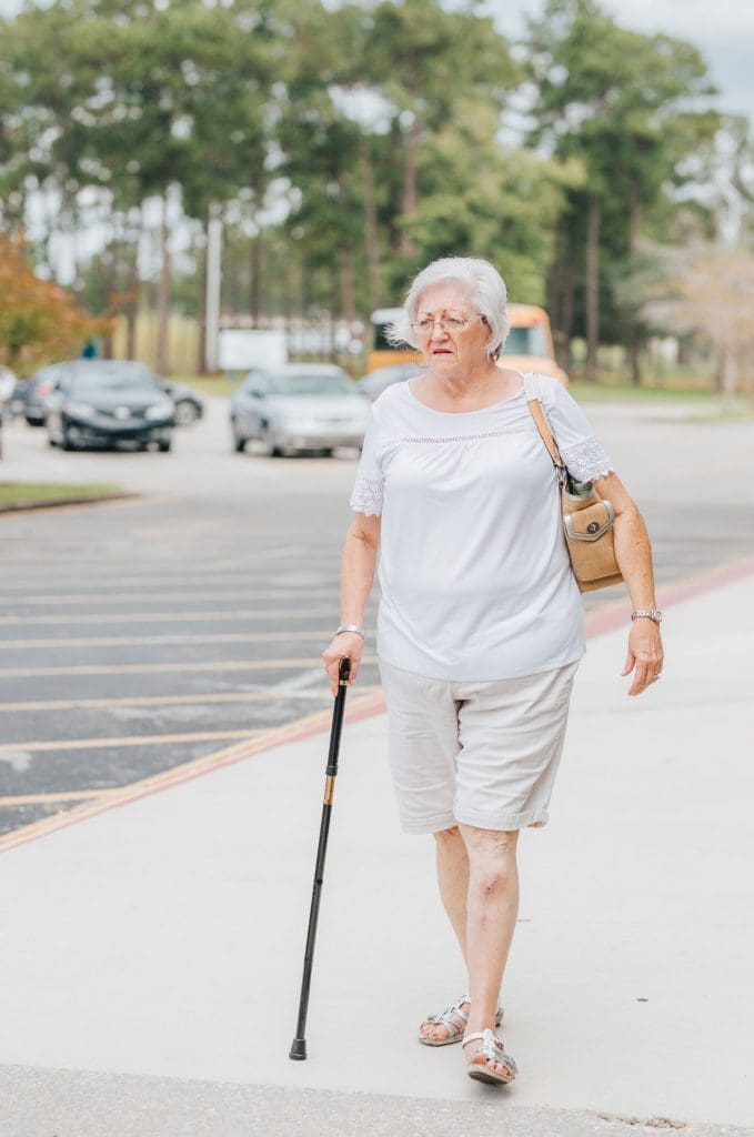 elderly lady walking with stick