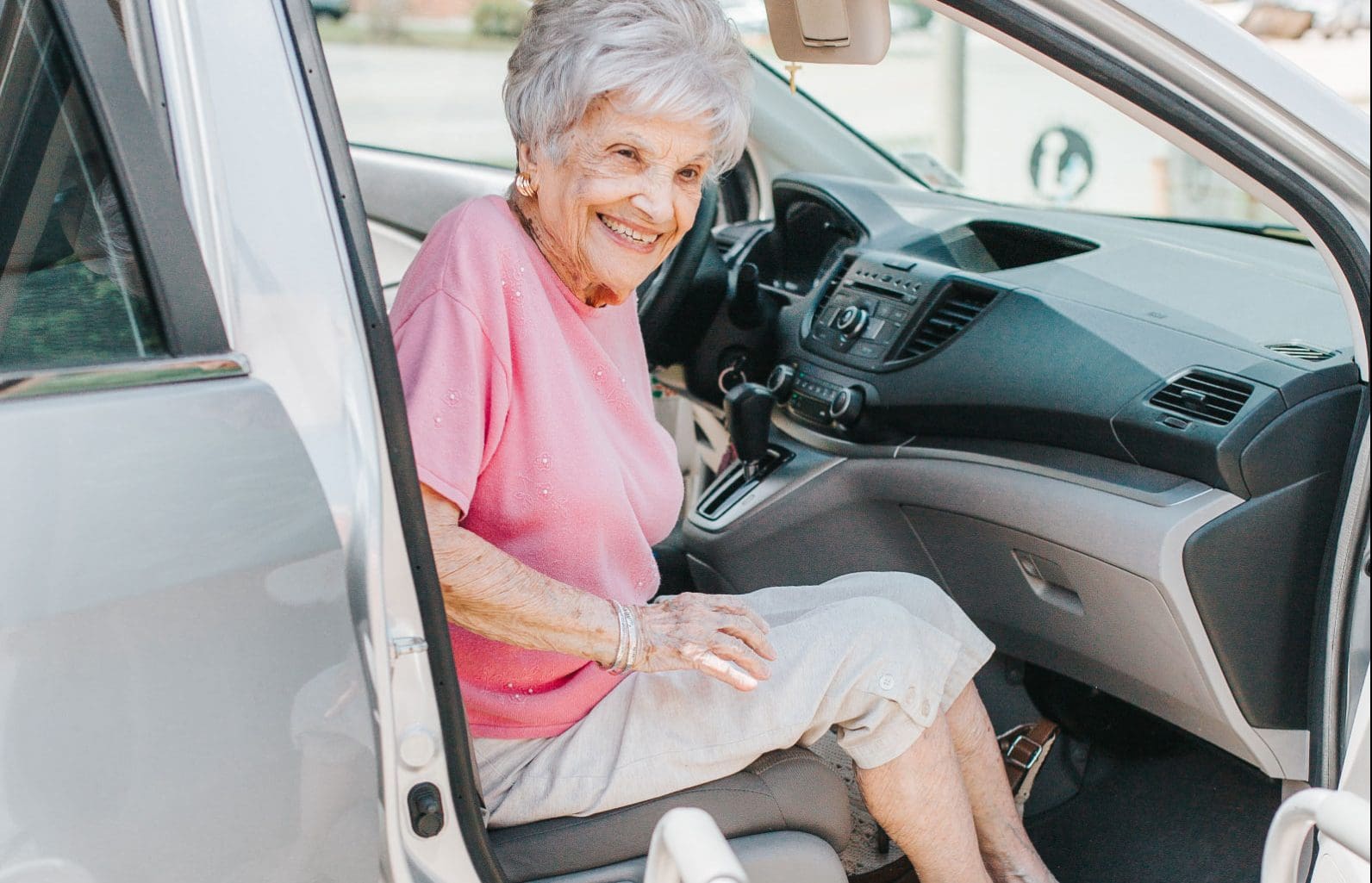 Elderly lady getting out of a car