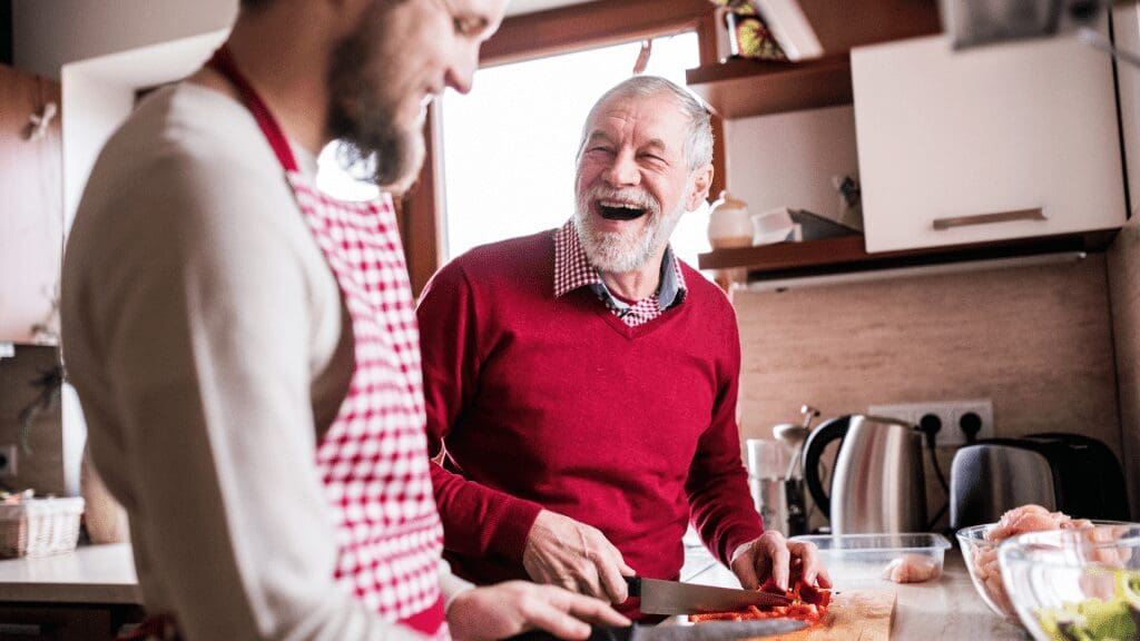 Older man and support working in the kitchen