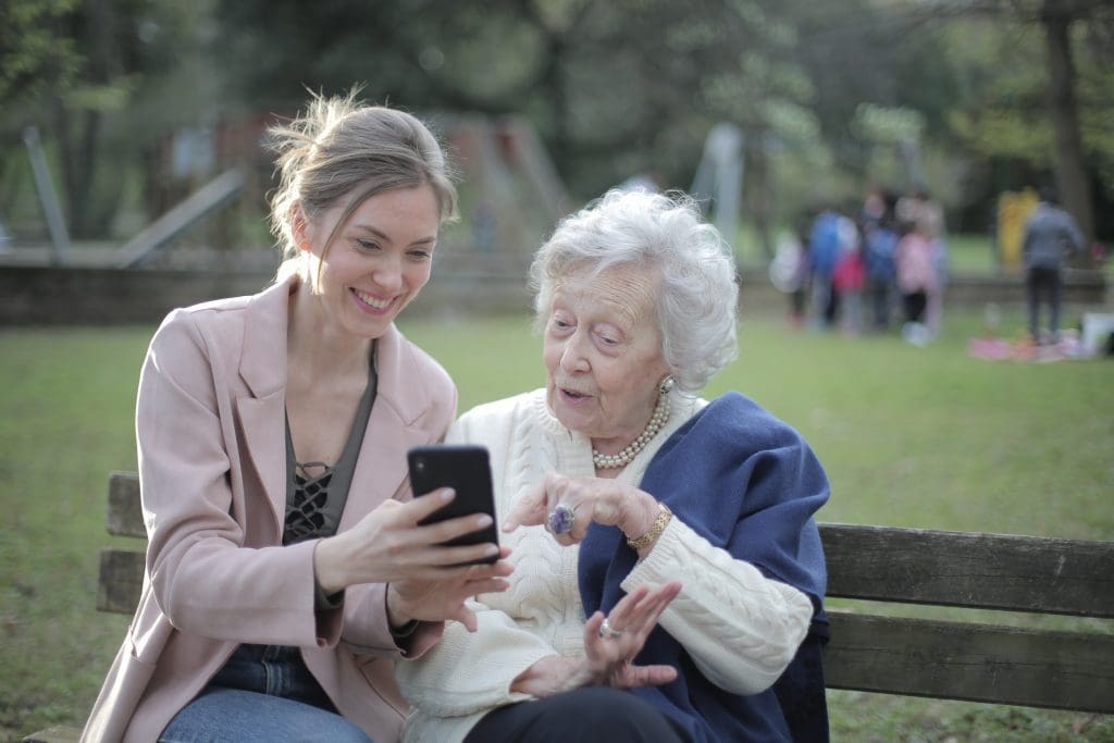 Aged care worker and client discussing wellness and reablement.